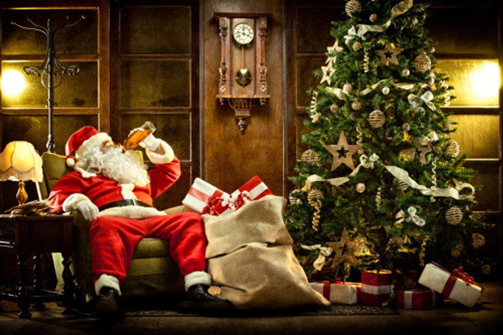 Santa drinking by the Christmas tree e1449821108677