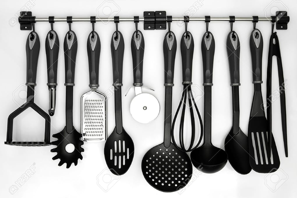 16559772 kitchen utensils hanging white background Stock Photo kitchenware