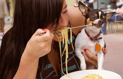 getty rm woman sharing pasta with dog EDIT1