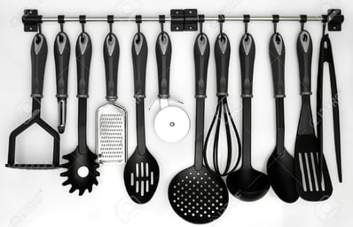 16559772 kitchen utensils hanging white background Stock Photo kitchenware