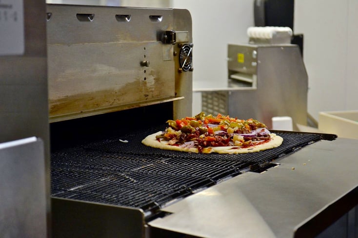 Pizza going into toaster