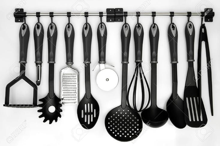 16559772 kitchen utensils hanging white background Stock Photo kitchenware