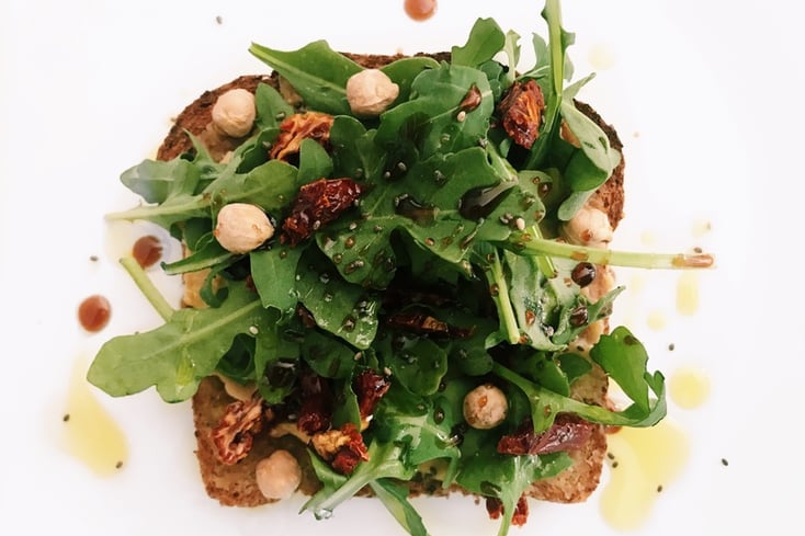 Roasted Garlic Hummus Toast with Fresh Arugula Salad