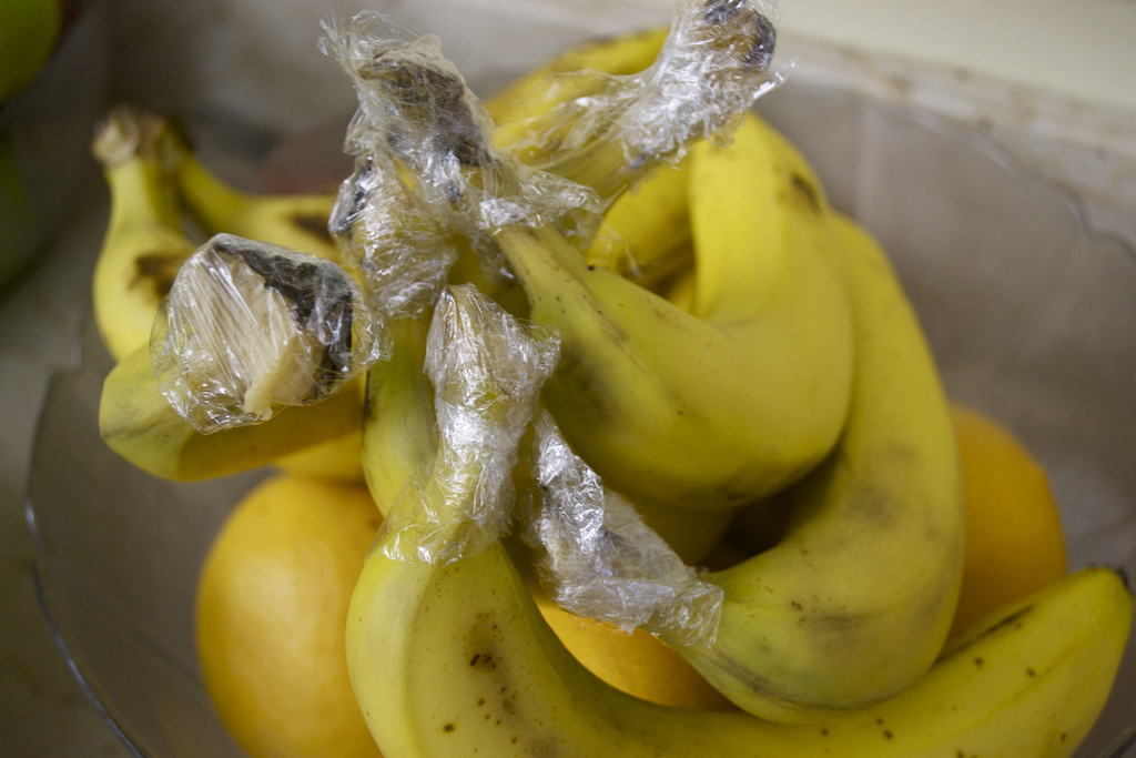 Keep bananas fresh longer by separating them and wrapping stem in plastic wrap