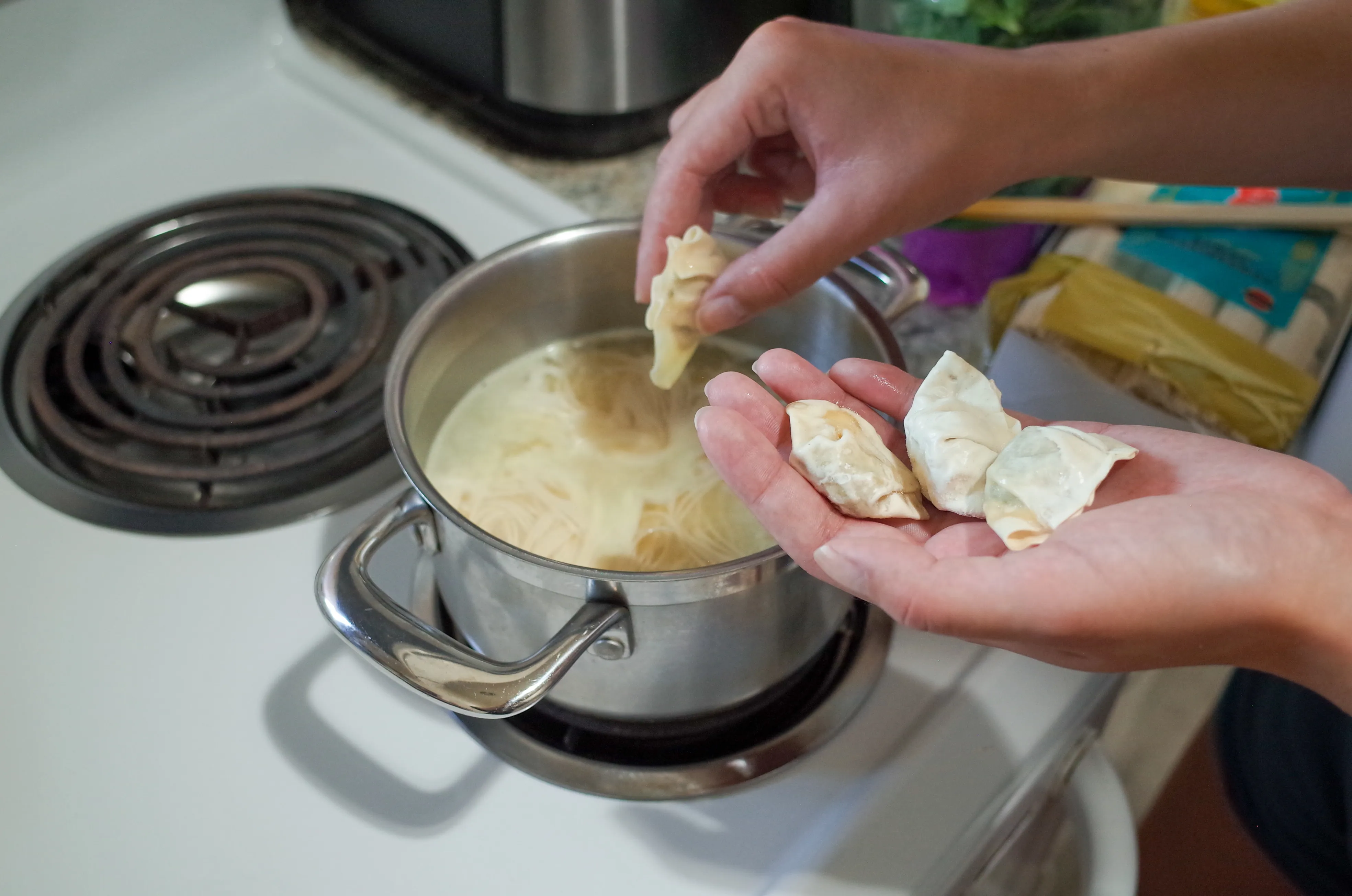 Placing frozen wontons in pot